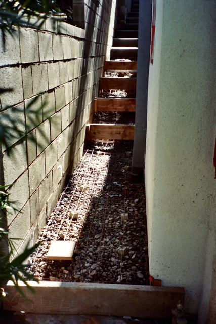 Walkway surface drain connected to foundation drainage Walkway surface drain connected to foundation drainage
