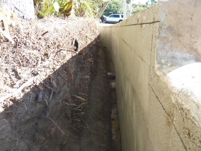 Planter wall voids and cracks filled with rapid set cement