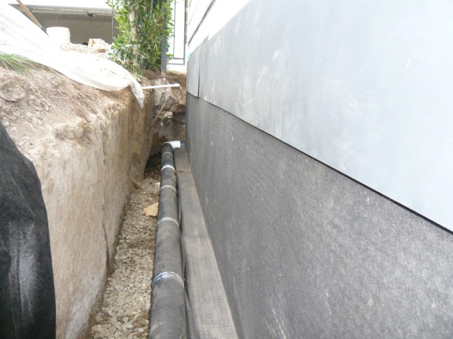 French drain positioned flush with footing