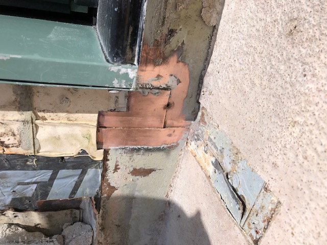 Defective deck copper flashings creating interior water damage