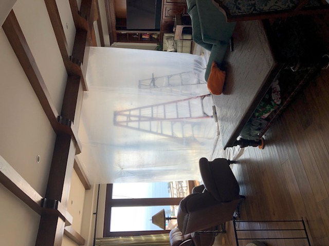 Containment barriers installed in living room below tile deck leak