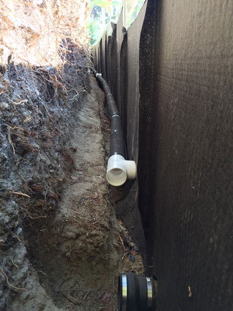 Curved planter wall french drains