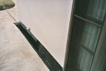 Sheet membrane applied over foundation and sill plate